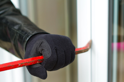 Burglar breaking in a house
